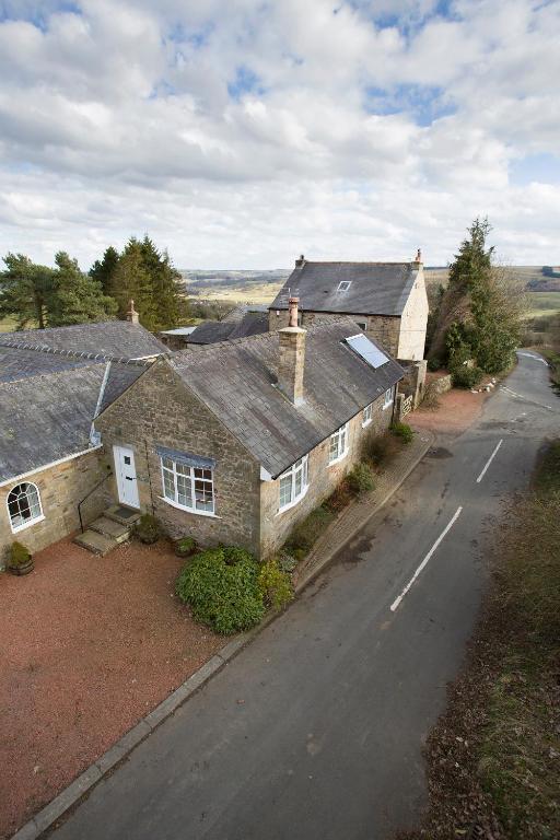 an old house on the side of a road at Stable Cottage in Bardon Mill