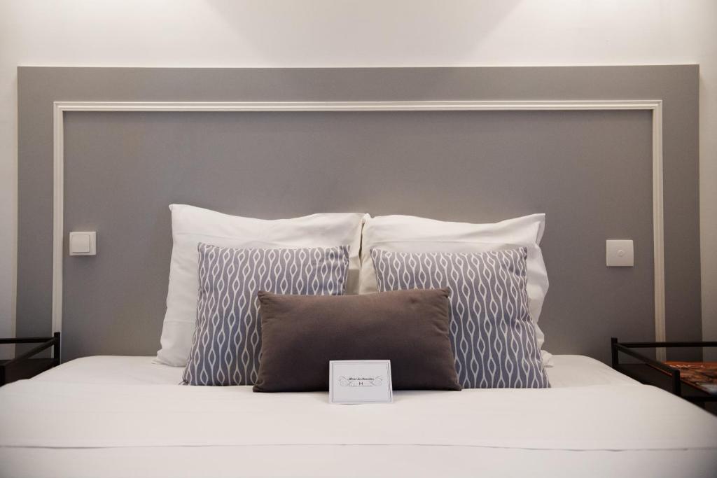 Postel nebo postele na pokoji v ubytování Hôtel Le Stanislas