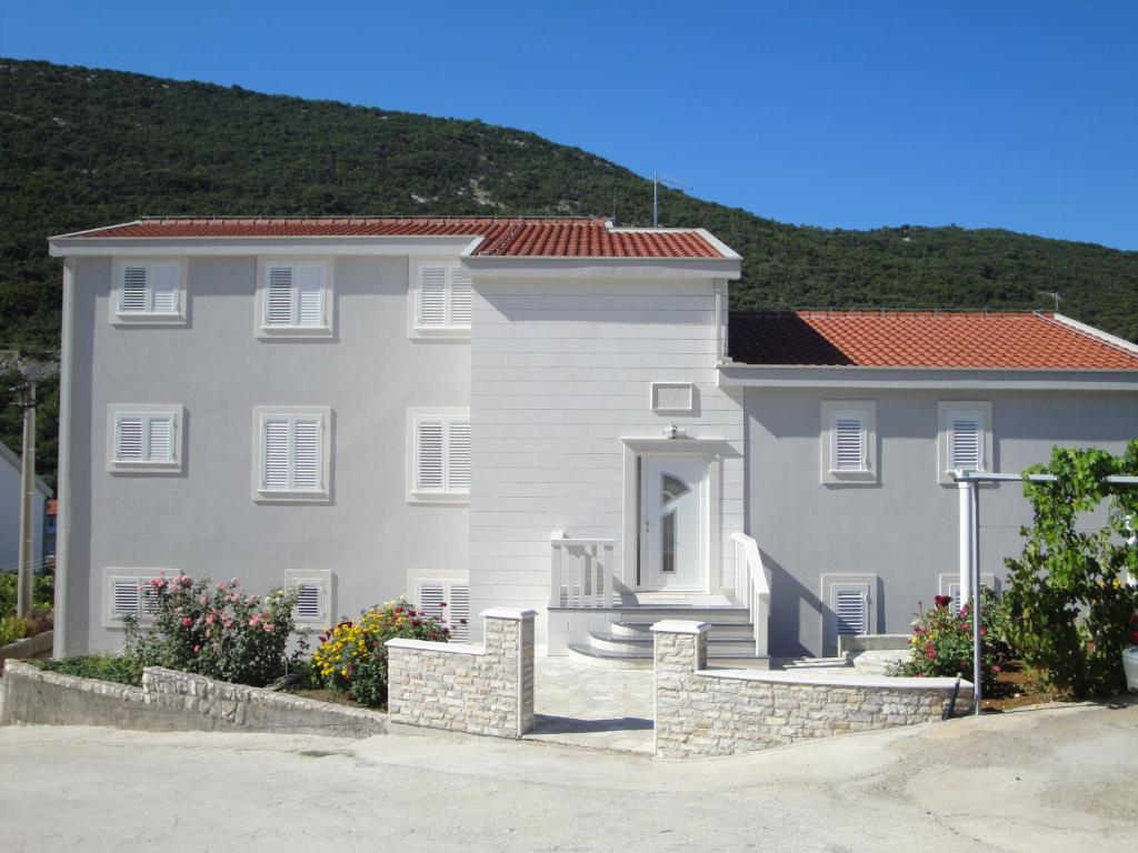 a large white house with a red roof at Villa Marica in Neum