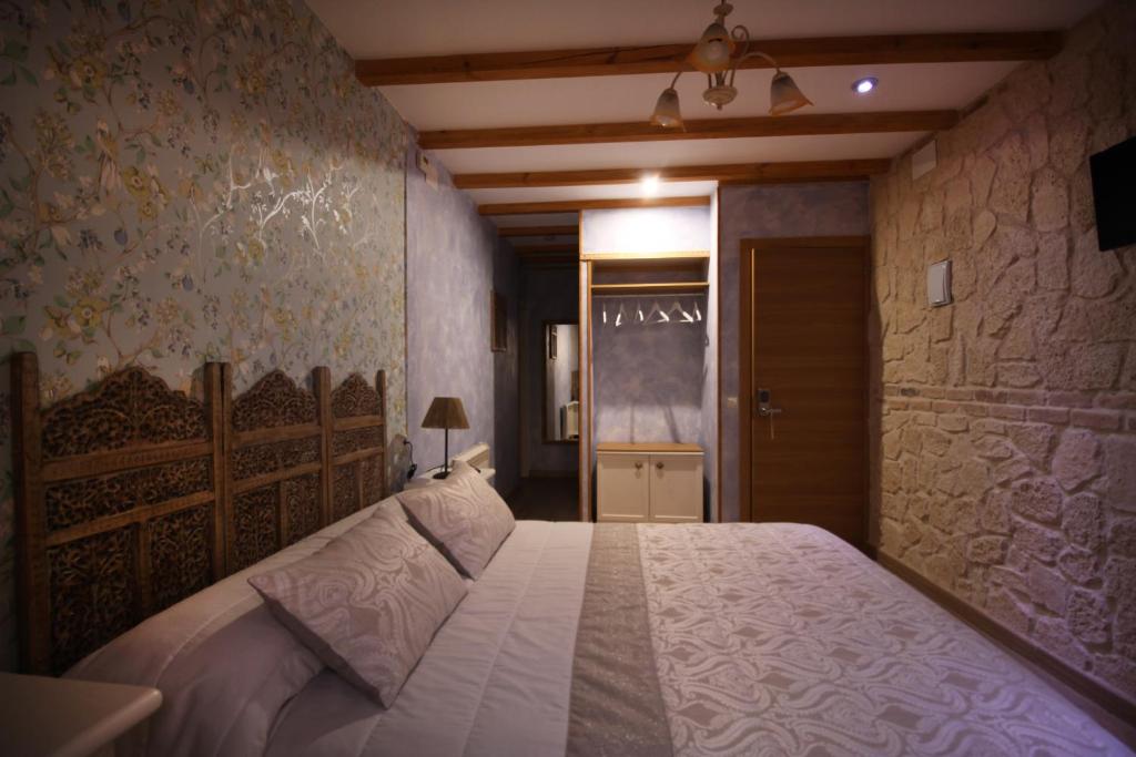 Postel nebo postele na pokoji v ubytování Posada de Peregrinos
