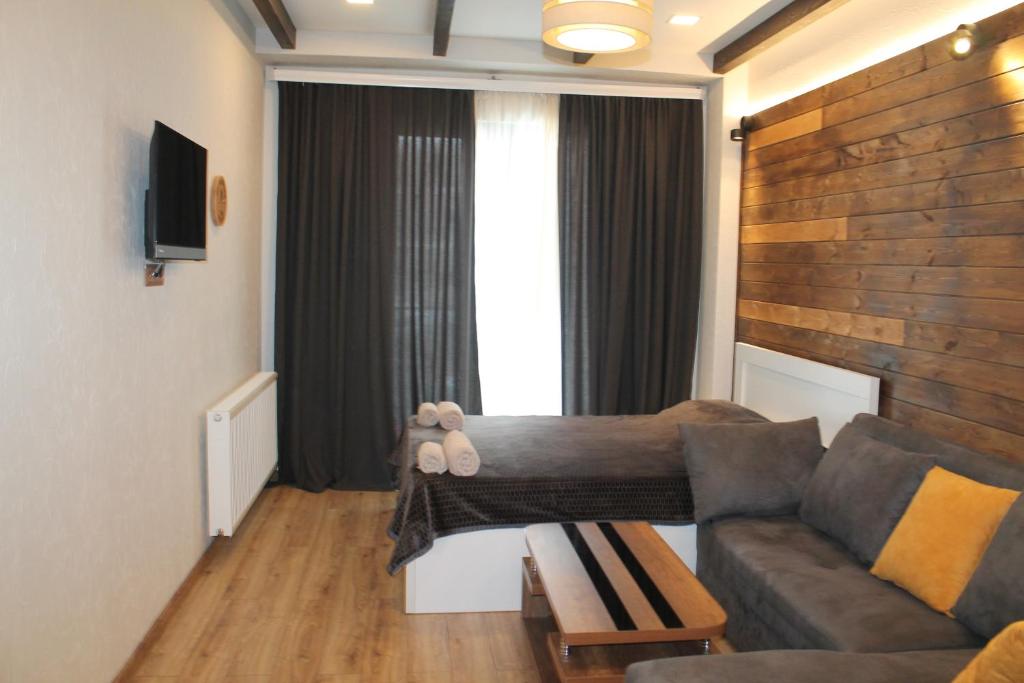 a living room with a couch and a table at Cozy Apartment Near Gondola loft1 in Gudauri