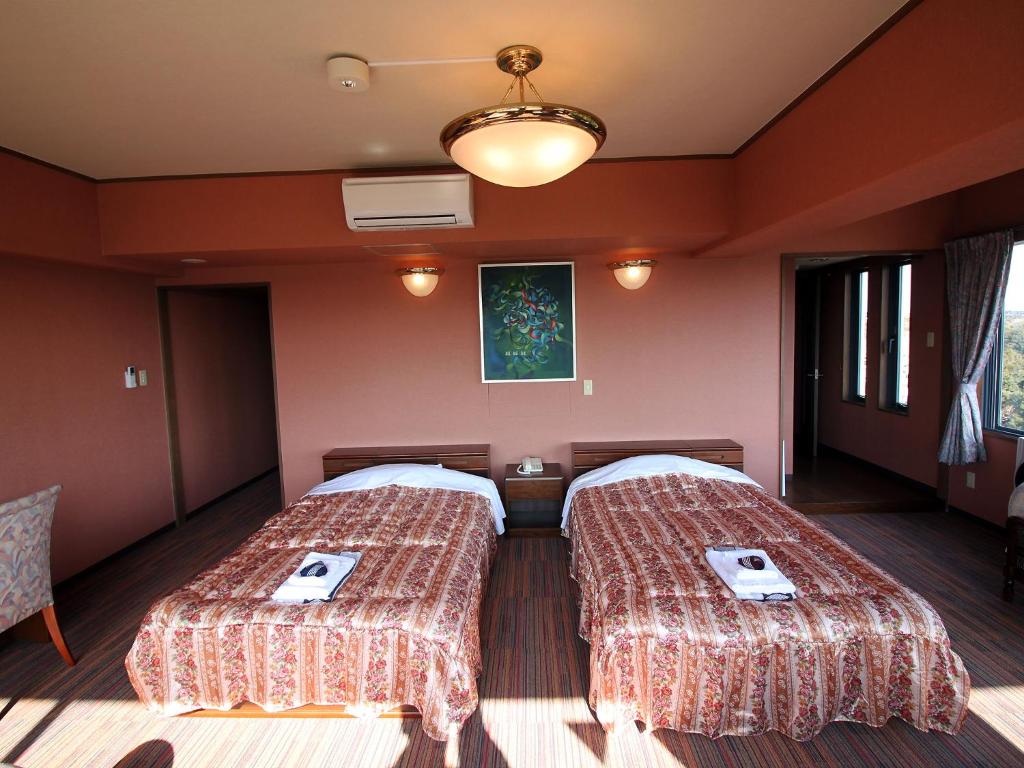 Postel nebo postele na pokoji v ubytování Kashikojima Hotel Bay Garden