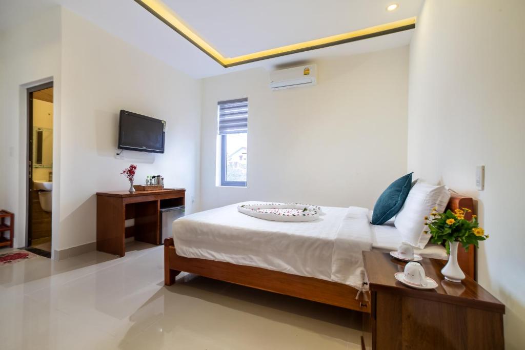 Postel nebo postele na pokoji v ubytování Sum villa Hoi An