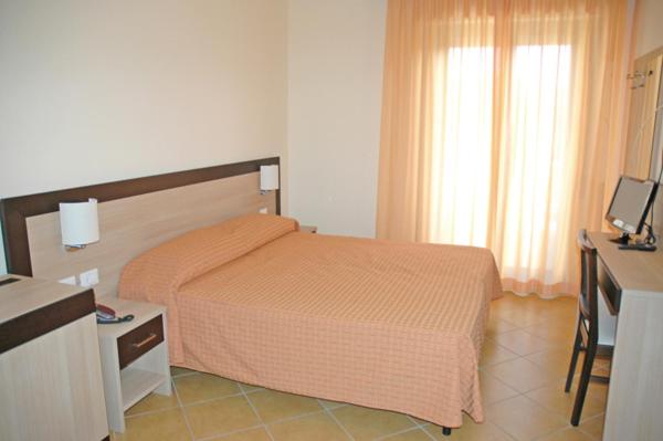 A bed or beds in a room at Affittacamere FloraMare