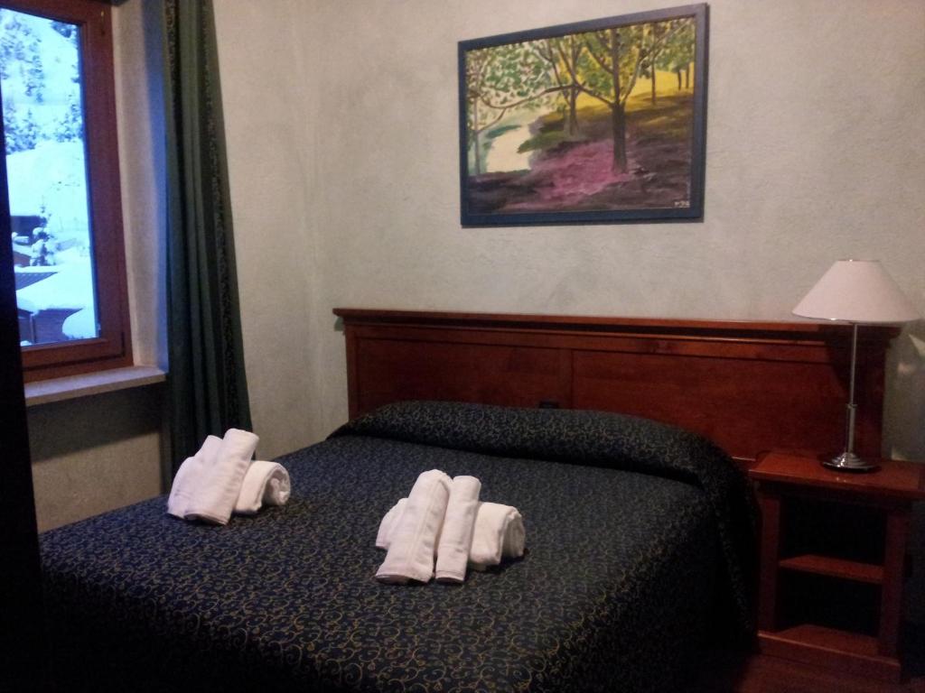 Postel nebo postele na pokoji v ubytování Hotel Clari