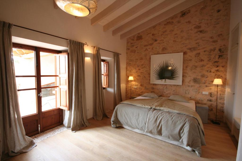 a bedroom with a bed and a large window at Living Casa Luna in Santanyi