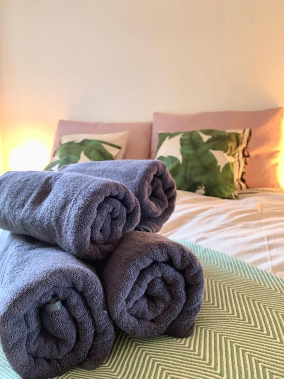a pile of towels sitting on top of a bed at Cute Pug Guest Room in Copenhagen