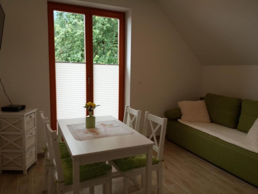 a living room with a table and a couch at Apartma Momo in Bohinj