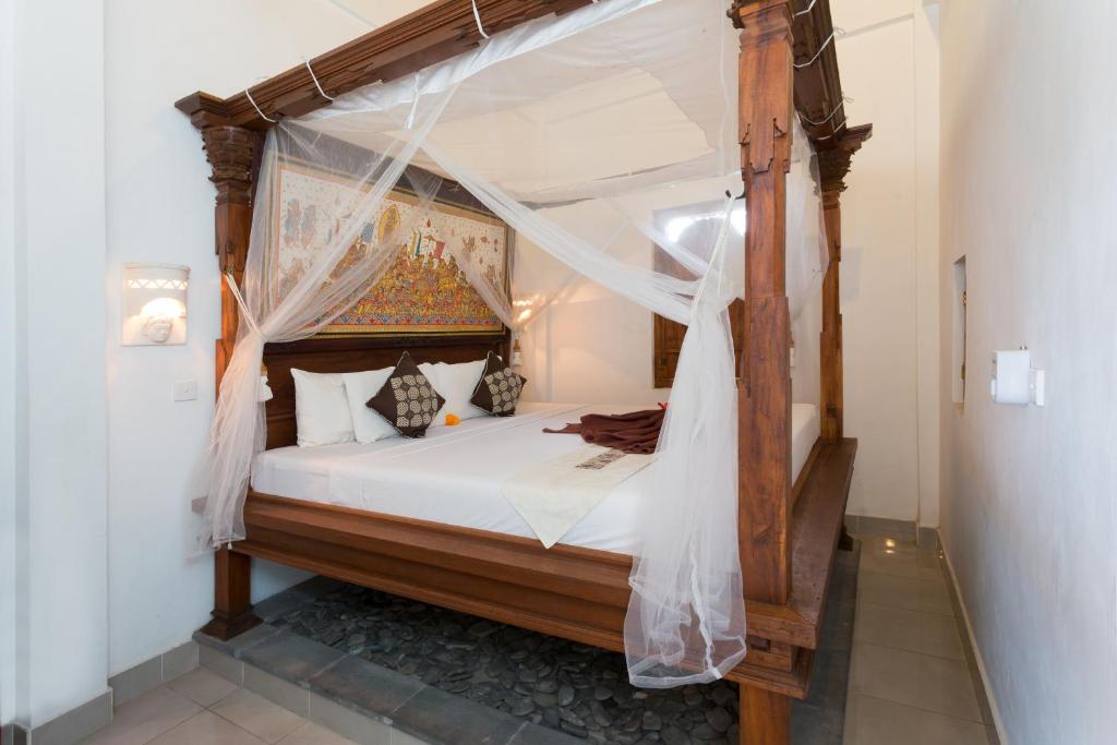 Postel nebo postele na pokoji v ubytování Bali Moon Guest House