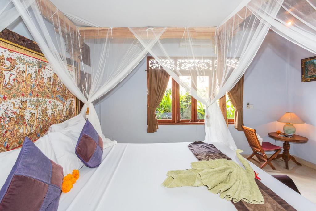 Postel nebo postele na pokoji v ubytování Bali Moon Guest House