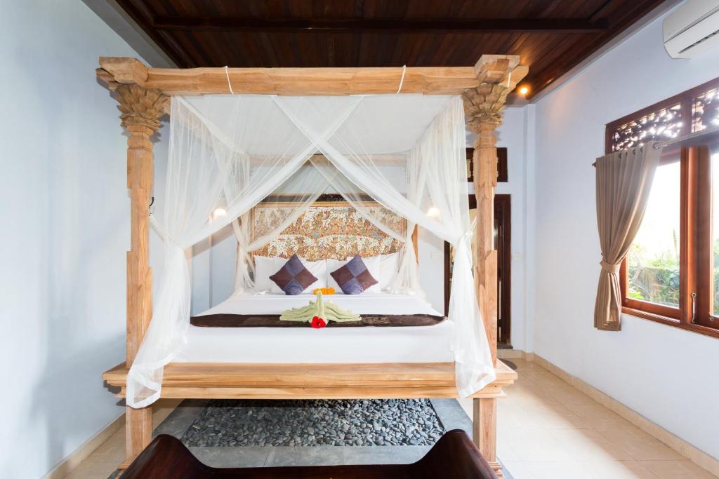 Postel nebo postele na pokoji v ubytování Bali Moon Guest House