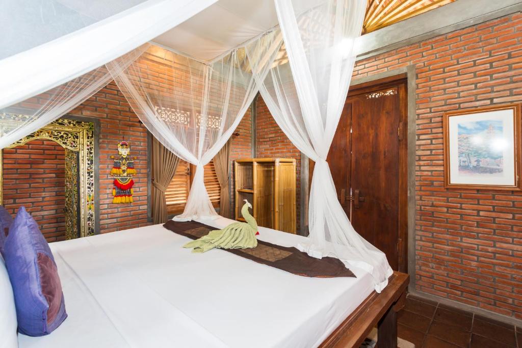 Postel nebo postele na pokoji v ubytování Bali Moon Guest House