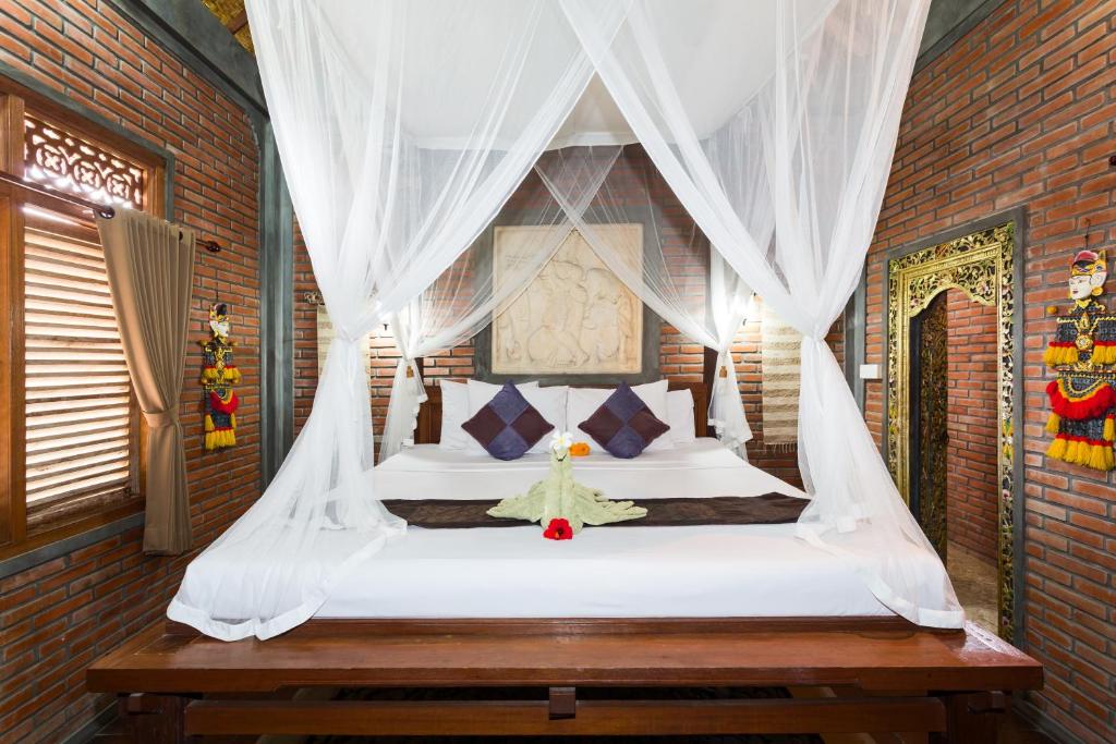 Postel nebo postele na pokoji v ubytování Bali Moon Guest House