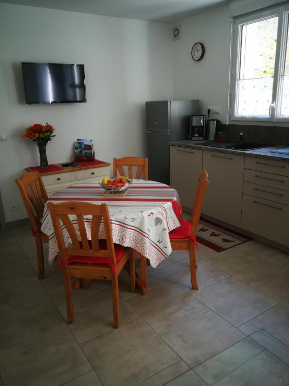 a kitchen with a table and two chairs and a table at boyard in Rochefort