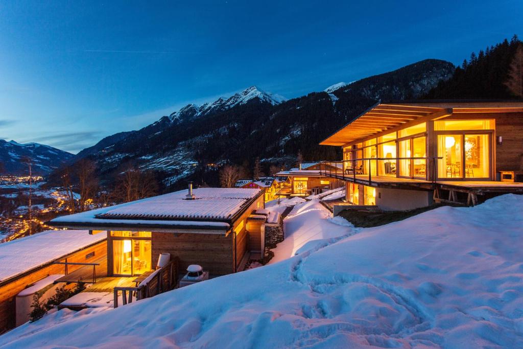 a house in the snow at night in the mountains at Alpenlofts in Bad Gastein