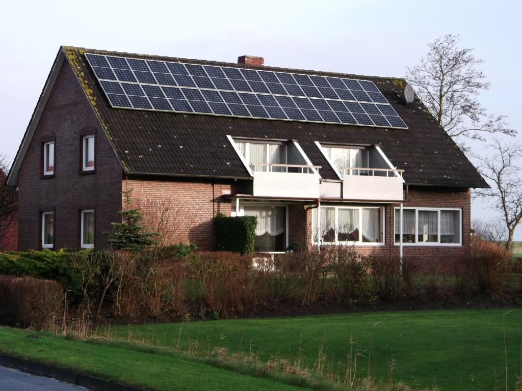 a house with solar panels on the roof at Fewo Minsen in Wangerland