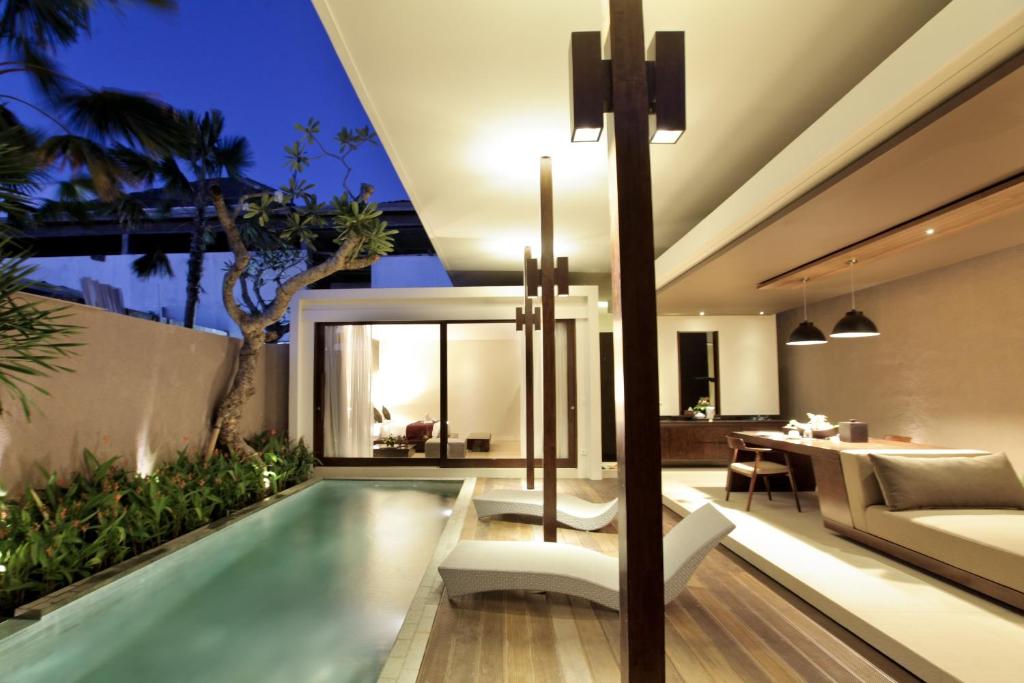 a villa with a swimming pool and a living room at Asa Bali Luxury Villas & Spa in Seminyak