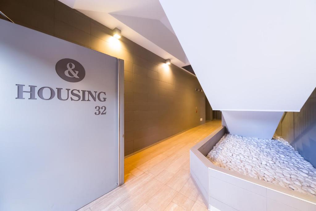 a room with a bed in a box next to a door at Housing32 Apartments in Milan