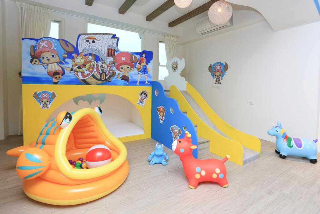 a childs room with a playroom with toys and a play set at Chi Heng Homestay in Luodong