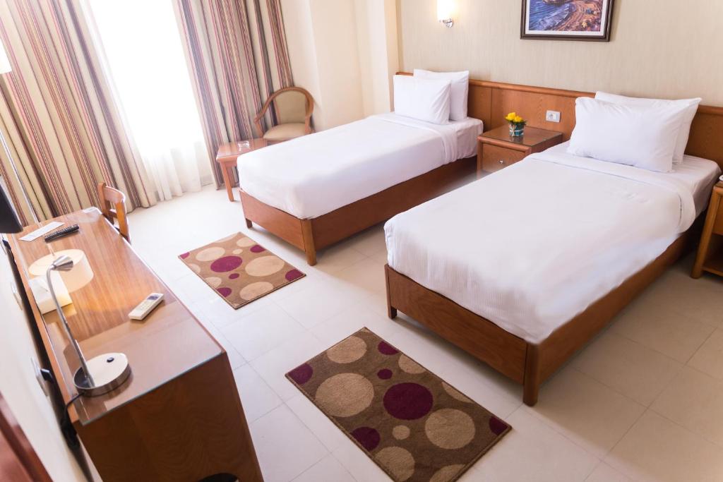 Postel nebo postele na pokoji v ubytování The Grand Plaza Hotel Smouha