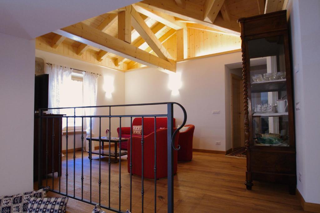 een woonkamer met een rode koffer in een kamer bij Tana dell'Orso in Pelugo