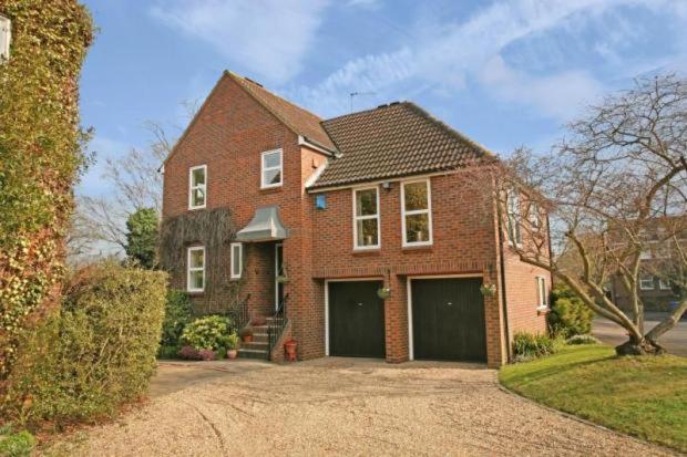 a brick house with a garage in a driveway at Agars Place, Datchet in Datchet