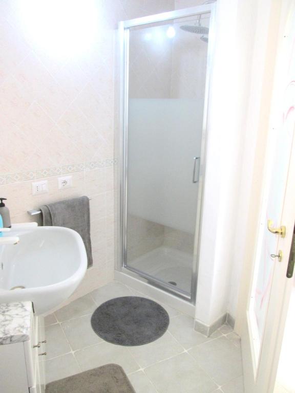 a bathroom with a shower and a sink at Sardinia Yellow House in Solanas