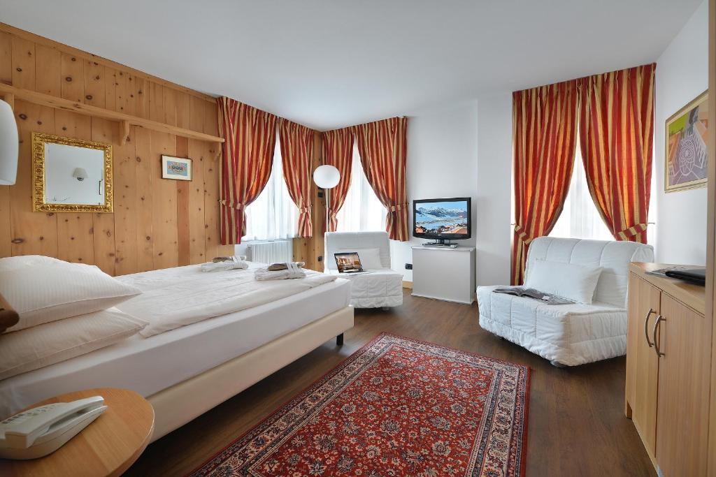 Postel nebo postele na pokoji v ubytování Hotel Livigno