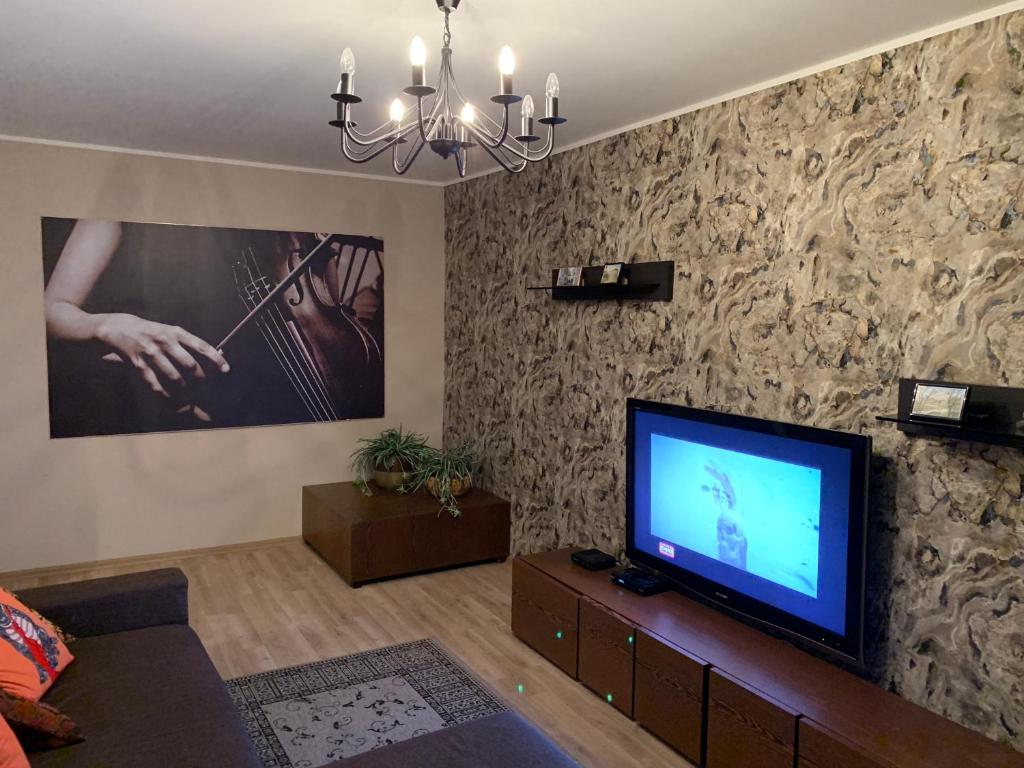 a living room with a flat screen tv on a wall at Just Apartments in Tallinn