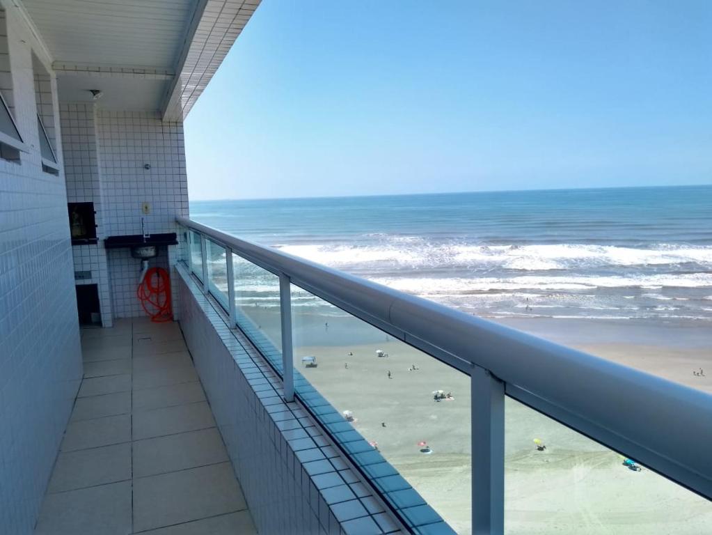 a view of the beach from the balcony of a building at VILA CAIÇARA-FRENTE P/MAR in Solemar