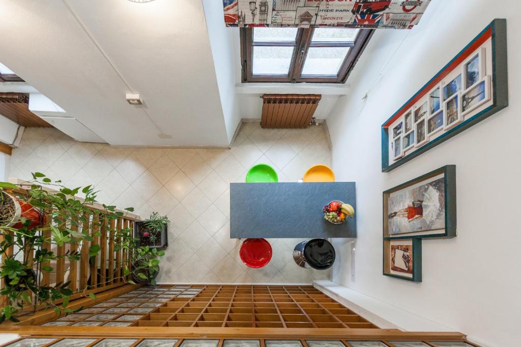 an attic room with a staircase and plants at RIPAMONTI 22 in Milan