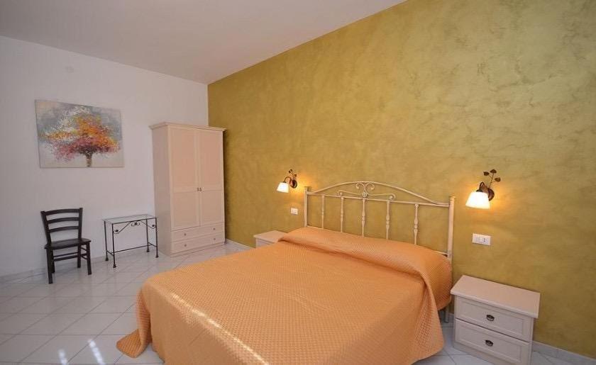 Postel nebo postele na pokoji v ubytování B&B Verso il Faro