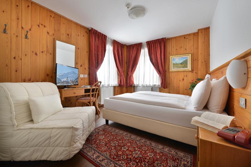 Postel nebo postele na pokoji v ubytování Hotel Livigno