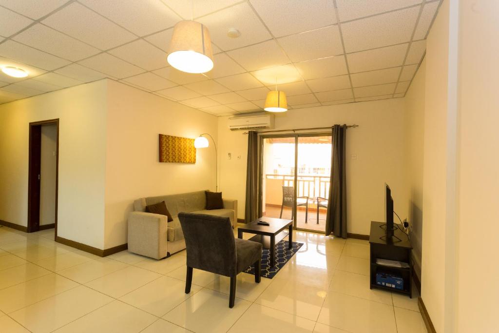 a living room with a couch and a table at La Casa Baatsona Apts in Accra