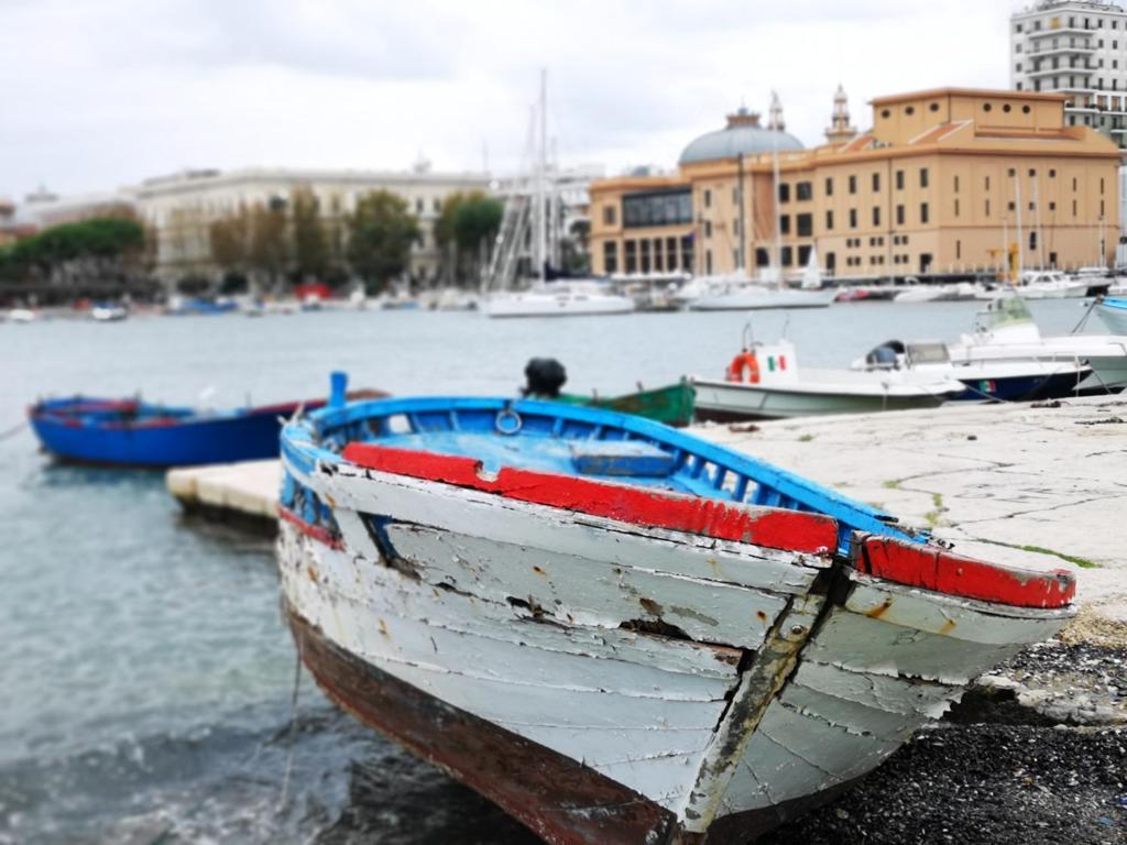 a boat sitting on the shore of a harbor at B&B L'annunziata in Bari