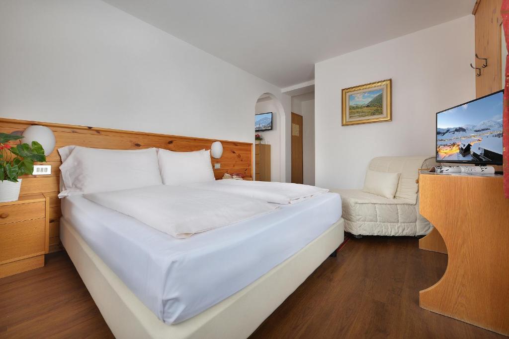Postel nebo postele na pokoji v ubytování Hotel Livigno