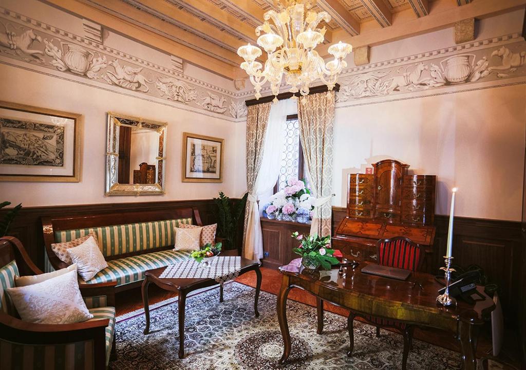 a living room with a couch and a table at Heritage Hotel Cardo in Split