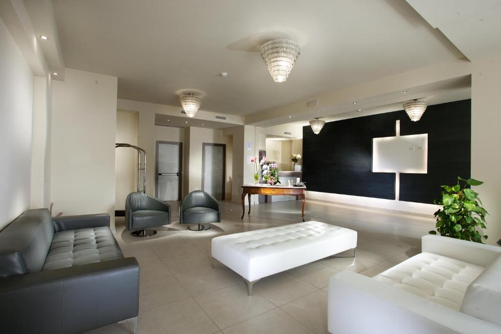 a living room with a couch and chairs and a table at Residence Elisabetta in Cesenatico