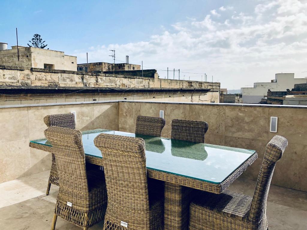 a table and chairs on top of a roof at Holiday townhouse in Sliema centre in Sliema
