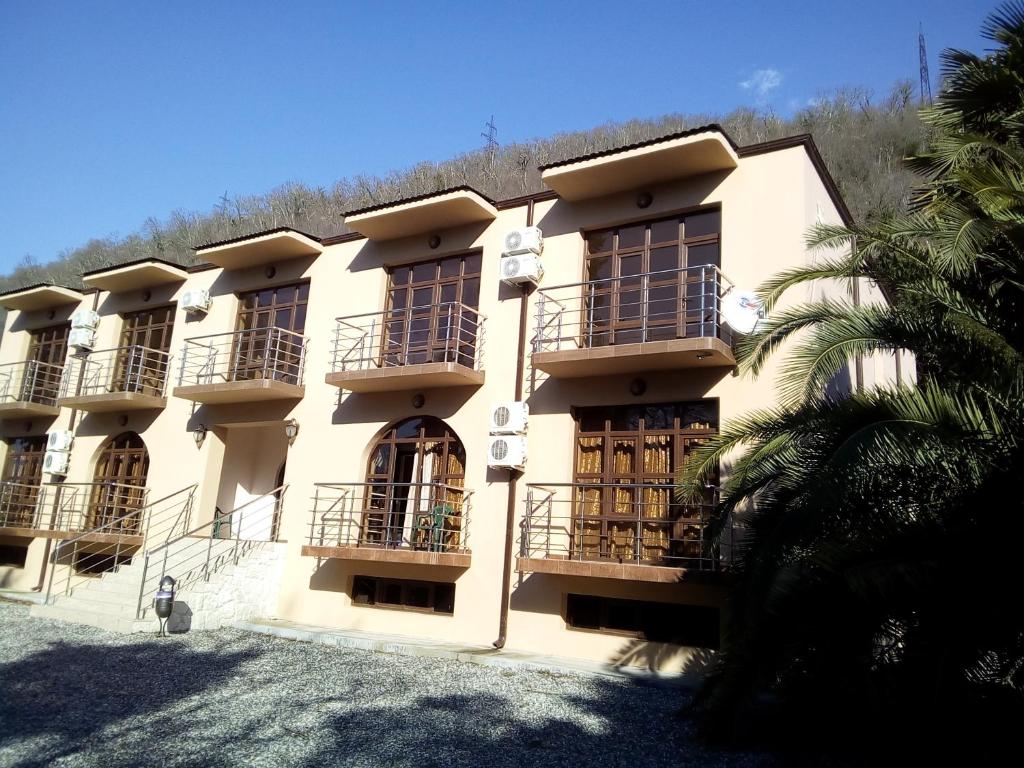 a building with balconies on the side of it at Inn Rif in Gagra