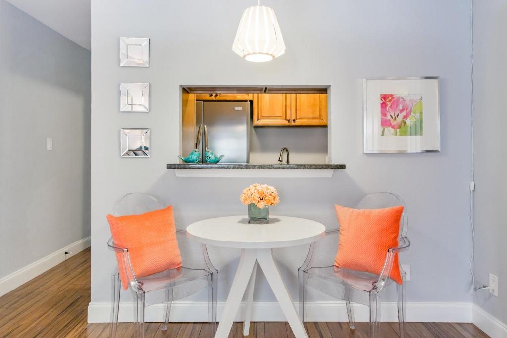 a dining room with a white table and two chairs at 1700 Nueces Street in Austin