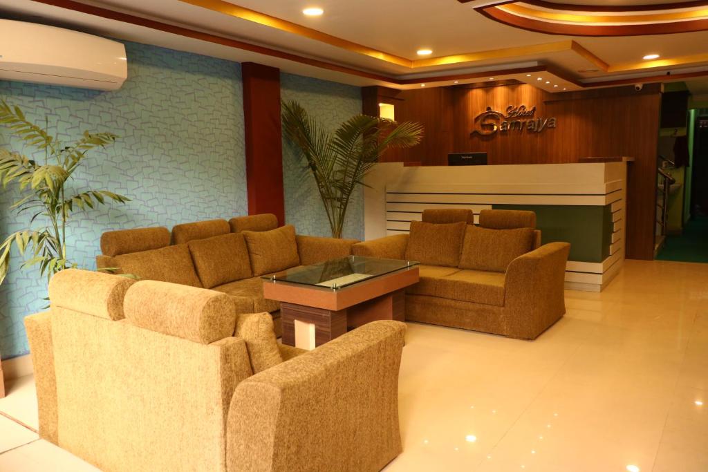 a lobby with two couches and a table and chairs at Hotel Samrajya Pvt. Ltd. in Kathmandu