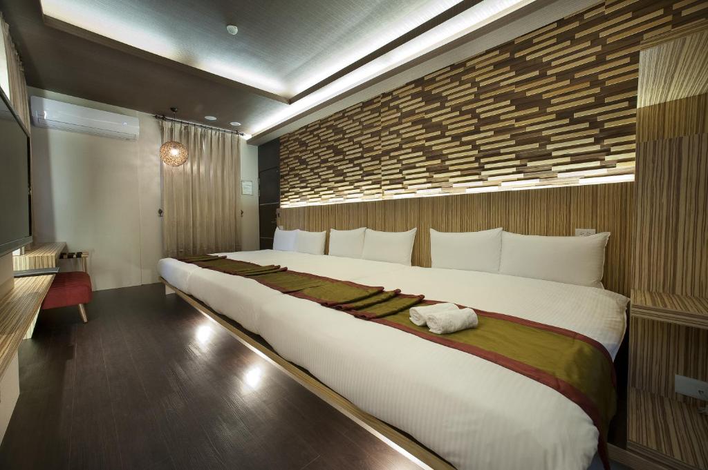 Postel nebo postele na pokoji v ubytování One Fukun Hotel