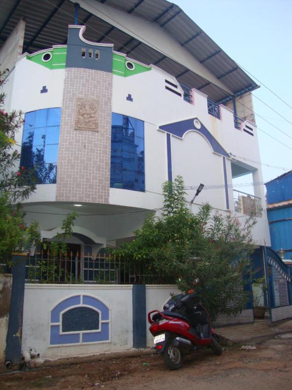 a scooter parked in front of a building at RR Home Stay in kāraikāl
