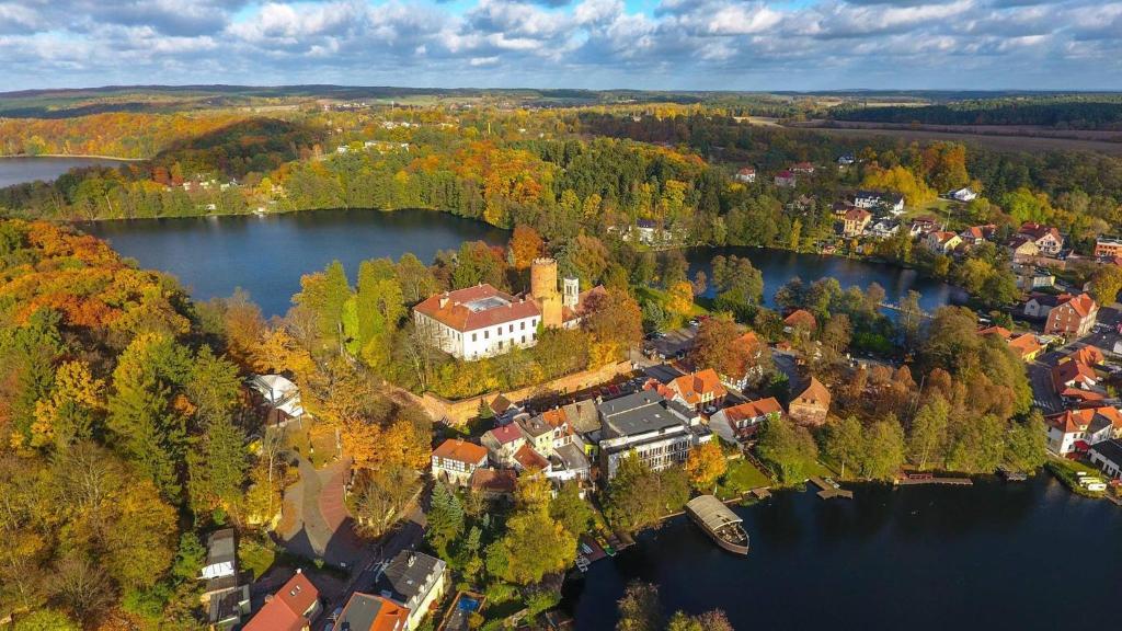 an aerial view of a town on a lake at Zamek Joannitów in Łagów