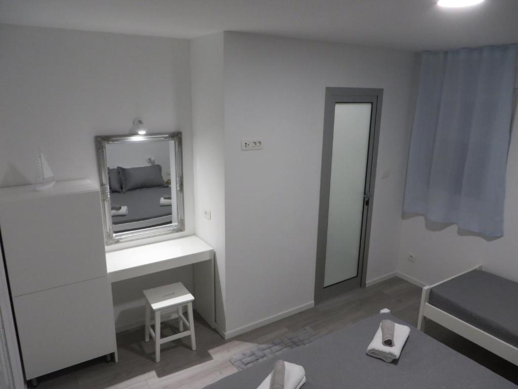 Posteľ alebo postele v izbe v ubytovaní Apartmani Raos