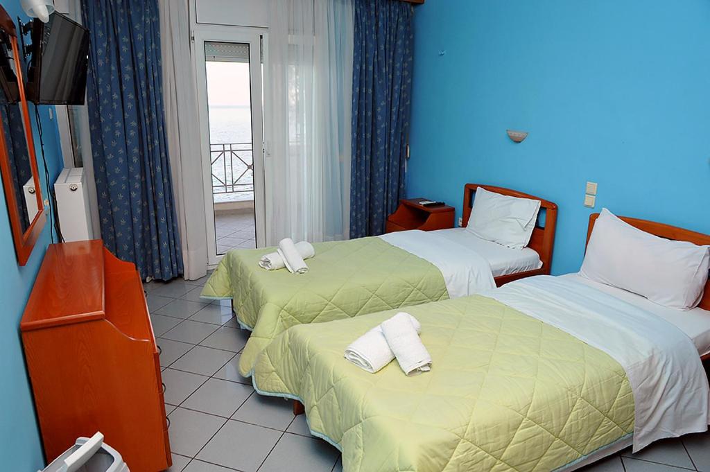 Postel nebo postele na pokoji v ubytování Hotel Pelagos Studios