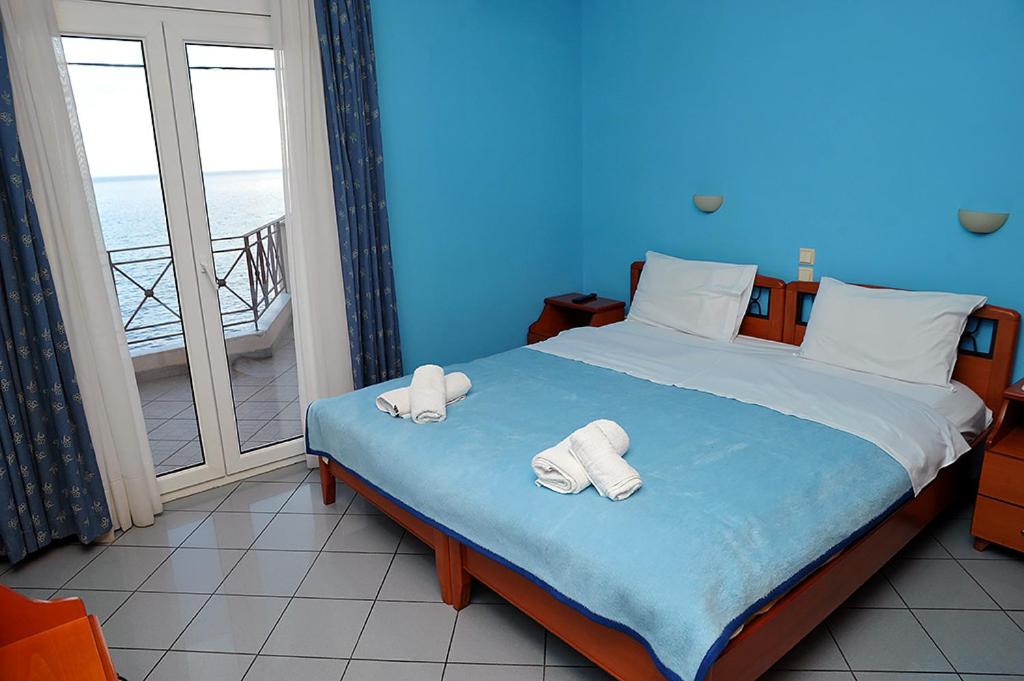 Postel nebo postele na pokoji v ubytování Hotel Pelagos Studios
