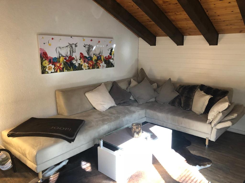 a living room with a couch and a table at Chalet Memory in Zermatt