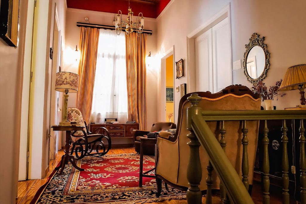 a room with a staircase and a living room at Athens Quinta in Athens
